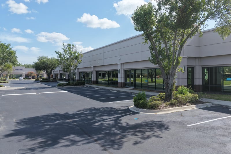 Parking lot with mature trees at 10550 Deerwood Park Blvd, Jacksonville, FL 32256