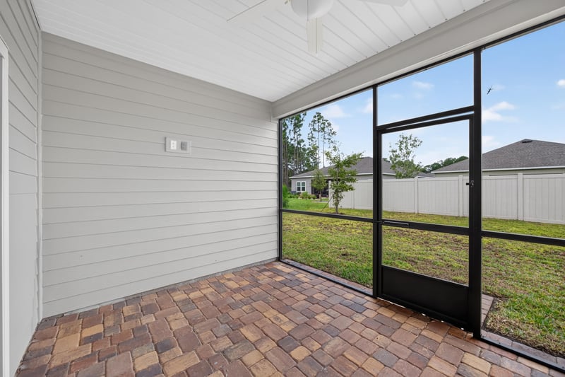 Screened patio with paver flooring at 9905 Ansley Lake Dr, Jacksonville, FL