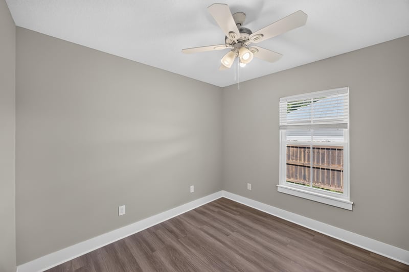 Empty bedroom with window and ceiling fan at 2855 N 8th St, St. Augustine, FL 32084