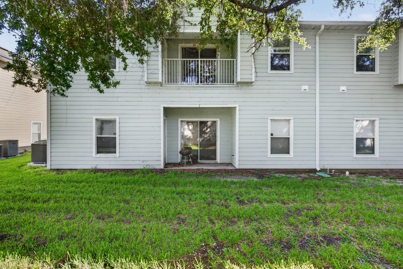 Rear exterior of building with open lawn at 7047 Deer Lodge Cir, Jacksonville