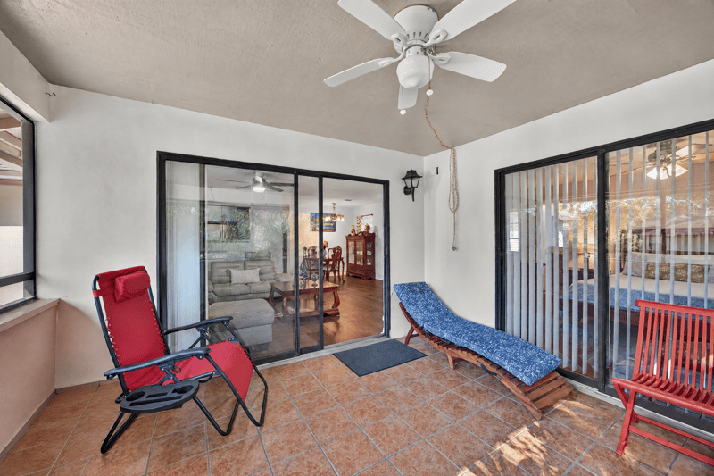 Screened porch with sliding doors and seating at 10150 Belle Rive Blvd, Jacksonville, FL