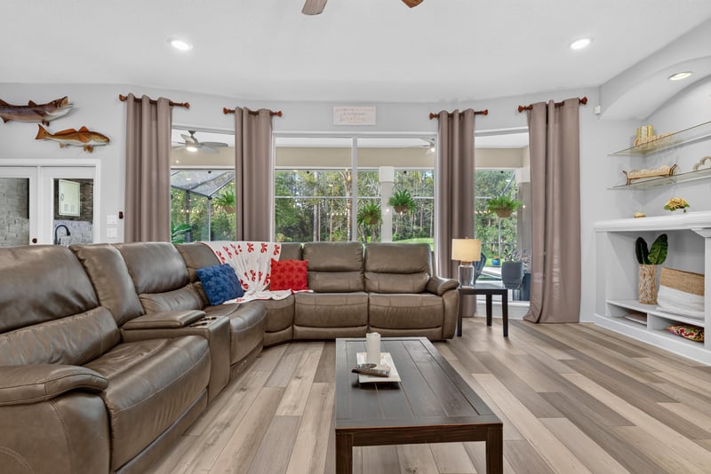 Living room with sectional sofa and windows at 2304 Spring Hill Ct, Orange Park, FL