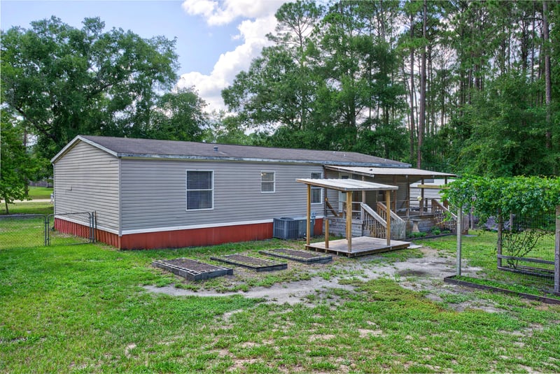 Side exterior view with attached shed at 2549 Snapdragon Ave, Middleburg, FL 32068
