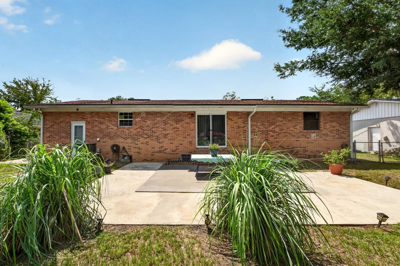 Backyard concrete patio and lawn at 1847 Grove Park Dr, Orange Park, FL