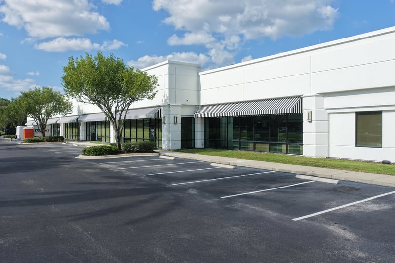 Building front with trees and parking lot at 10550 Deerwood Park Blvd, Jacksonville, FL 32256