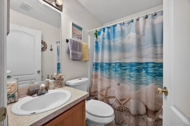 Bathroom with sink vanity and beach-themed shower curtain at 145 Dover Bluff Dr, Orange Park, FL
