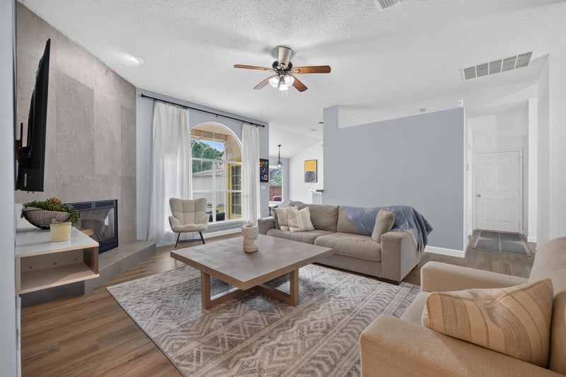 Living room with fireplace and area rug at 8921 Needlepoint Pl, Jacksonville, FL 32244