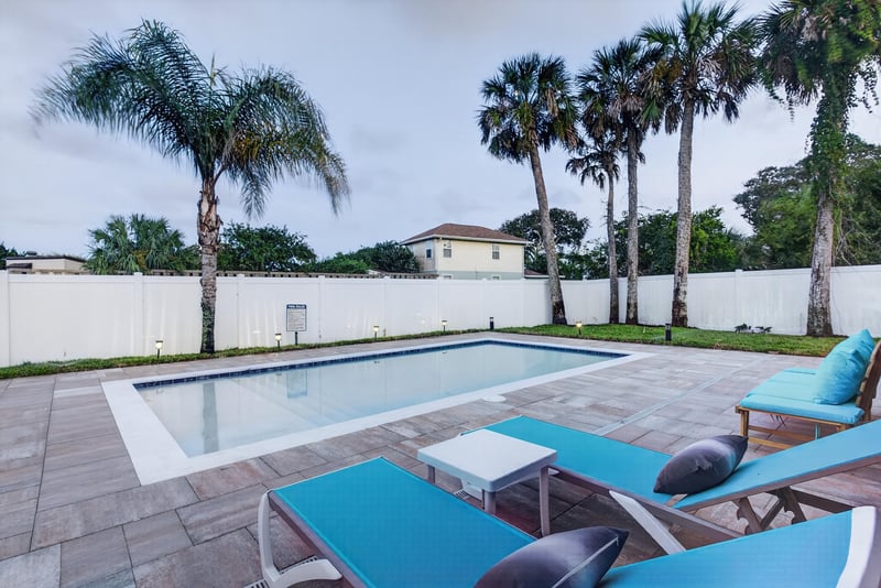 Backyard pool and patio with lounge chairs at 1525 8th St N, Jacksonville Beach, FL