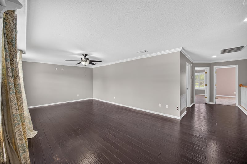 Empty room with wood floors and curtains at 1493 Greyfield Dr, St. Augustine, FL 32092