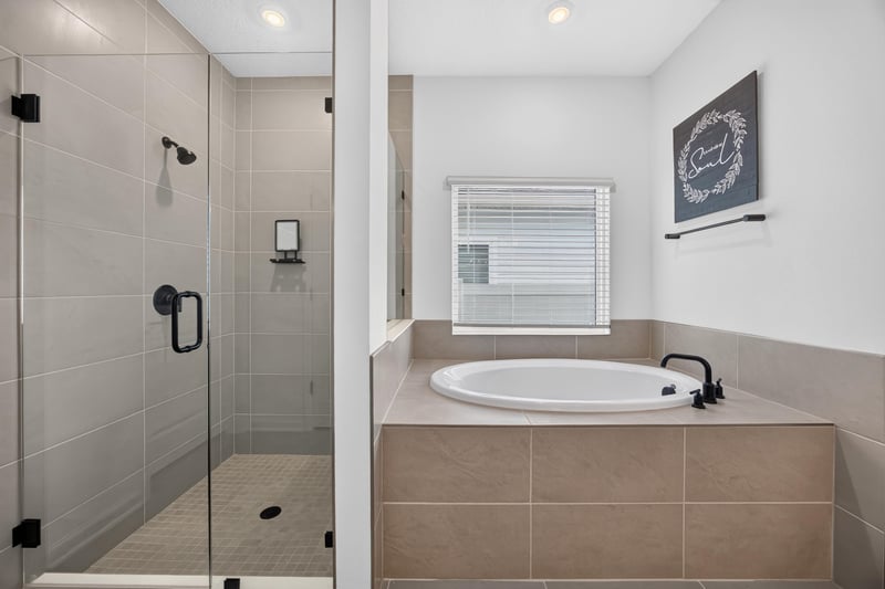 Primary bathroom shower and soaking tub detail at 2354 Jennings Farm Dr, Middleburg, FL 32068