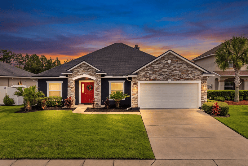 Front exterior at day-to-dusk with red door at 538 Porta Rosa Circle, St. Augustine, FL 32092