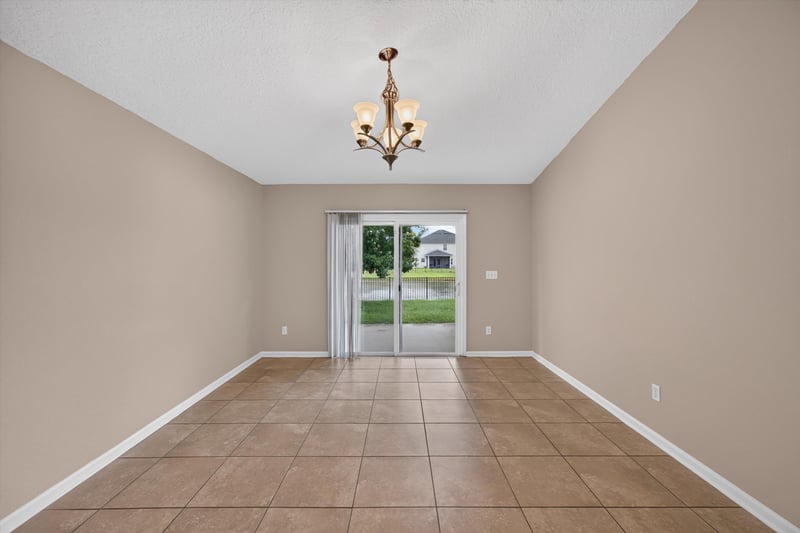 Living room with sliding glass door and tile floor at 469 Glendale Ln, Orange Park, FL