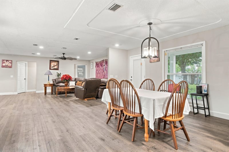 Open living and dining space with wood-look flooring at 357 Dillon Dr, Orange Park, FL