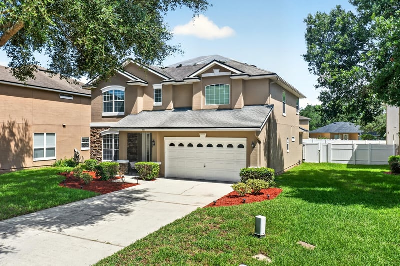 Front exterior from the side showing the three-car garage at 3660 Middlebrook Dr, Orange Park, FL 32065