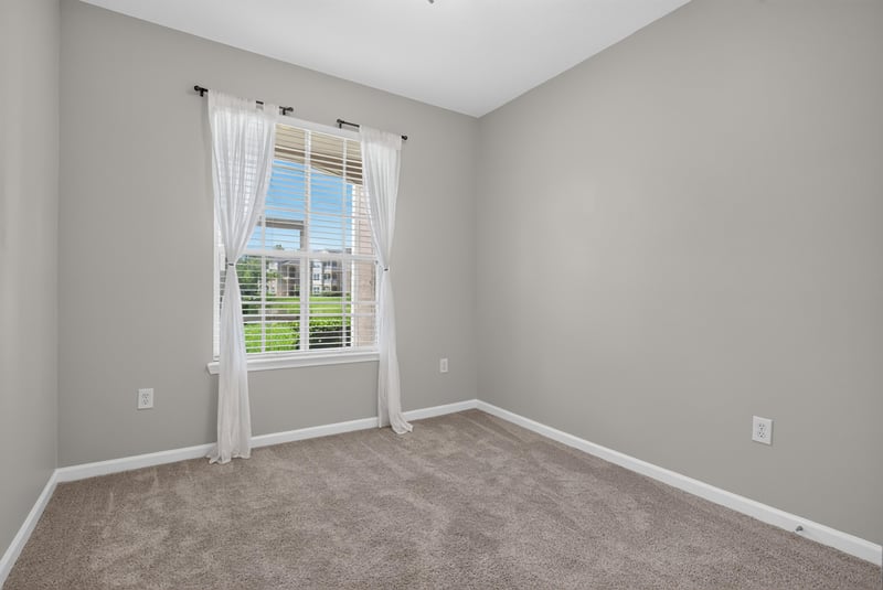 Bedroom with window and carpet at 7990 Baymeadows Rd E #404, Jacksonville, FL 32256