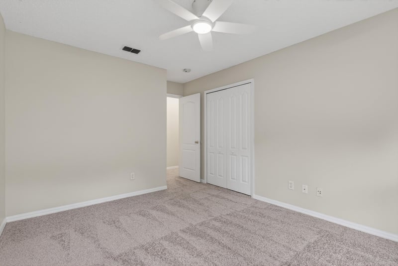 Bedroom with carpet, closet door and window at 1648 Glen Laurel Dr, Middleburg, FL 32068