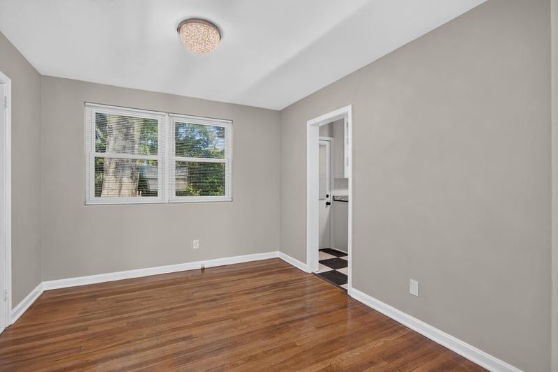 Empty room with windows and hardwood floors at 6338 Mercer Cir W, Jacksonville, FL