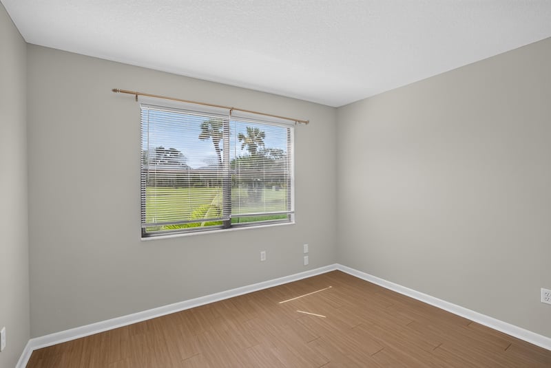 Bedroom with window and lawn view at 700 W Pope Rd unit h61, St. Augustine, FL 32080