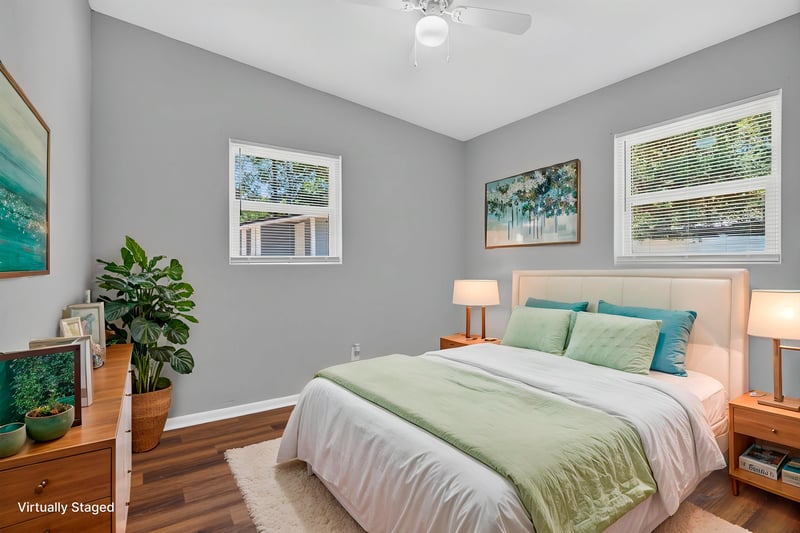Bedroom with virtually staged bed and corner windows at 1928 Montmarte Dr, Jacksonville, FL 32210