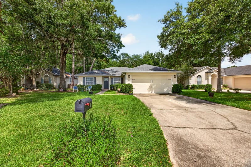 Front exterior with driveway and lawn at 145 Dover Bluff Dr, Orange Park, FL