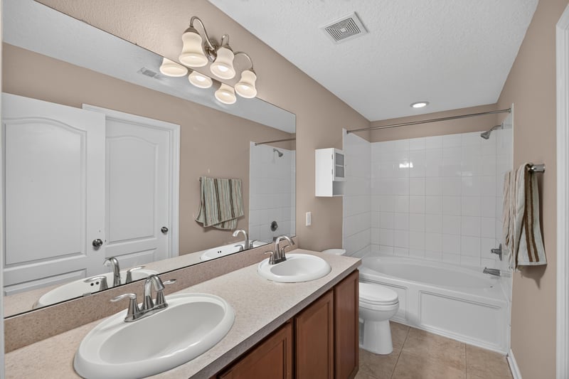 Bathroom with double vanity and tub-shower combo at 3762 Hartsfield Forest Cir, Jacksonville, FL 32277