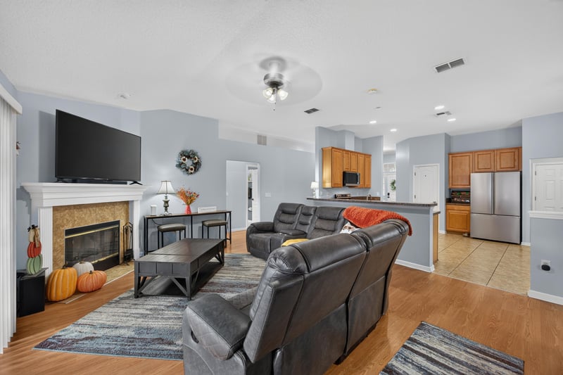 Family room fireplace open to kitchen at 3112 Silverado Cir, Green Cove Springs, FL 32043