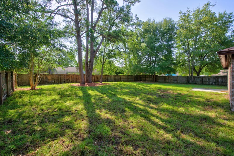 Backyard with fencing and mature trees at 8453 Boysenberry Ln W, Jacksonville, FL