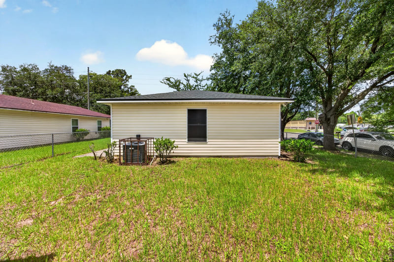 Rear exterior with AC unit and yard at 5375 Dodge Rd, Jacksonville, FL 32209