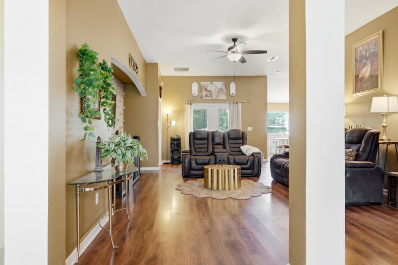 Open living room with hardwood floors and columns at 7392 Timber Falls Ct