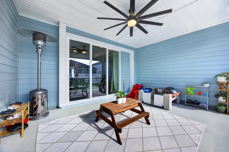 Covered lanai with picnic table and outdoor rug at 2354 Jennings Farm Dr, Middleburg, FL 32068