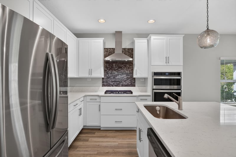 Kitchen with stainless refrigerator and tile backsplash at 75875 Saffron Ln, Yulee, FL 32097