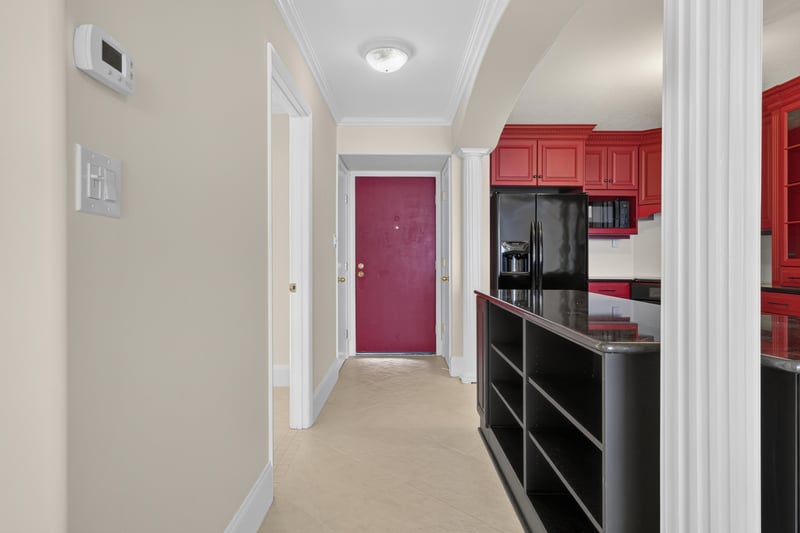 Kitchen entry with red cabinets and black appliances at 1301 1st St S