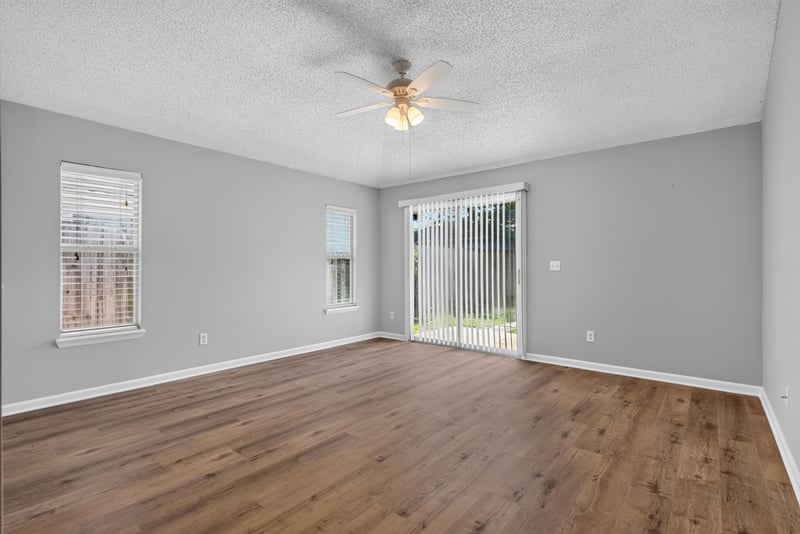 Living room with wood-look flooring and sliding door at 1108 Hidden Cove Cir S, Atlantic Beach, FL 32233