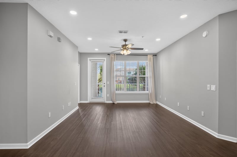 Living room with window and ceiling fan at 11251 Campfield Dr unit 4209, Jacksonville, FL 32256