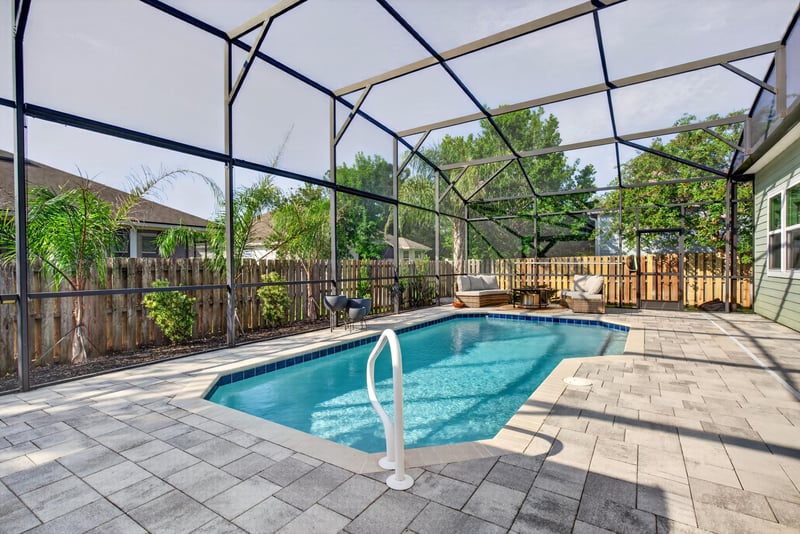 Pool steps within the screened enclosure at 3328 Southern Oaks Dr, Green Cove Springs, FL 32043