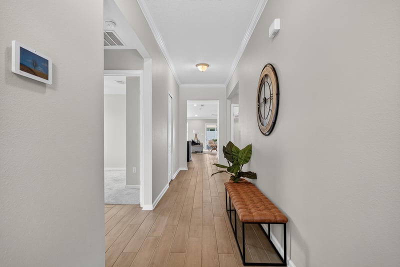 Entry hallway with wood bench and tile flooring at 10066 Andean Fox Dr, Jacksonville, FL 32222