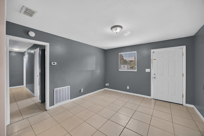 Living room shown empty with tile flooring at 6745 Jack Horner Ln, Jacksonville, FL 32210