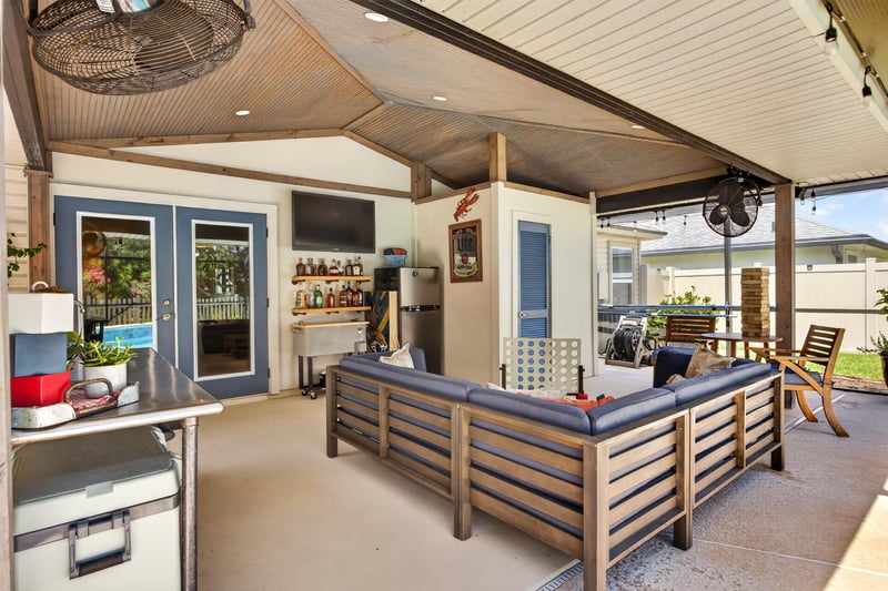 Covered patio with tv and grill at 1589 Backwater Drive, Middleburg, FL 32068