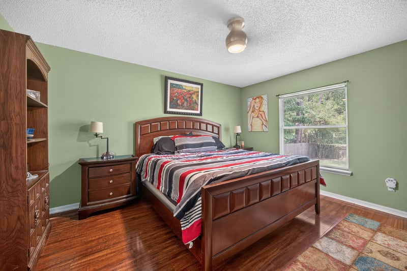 Bedroom with wood furniture and striped bedding at 145 Dover Bluff Dr, Orange Park, FL