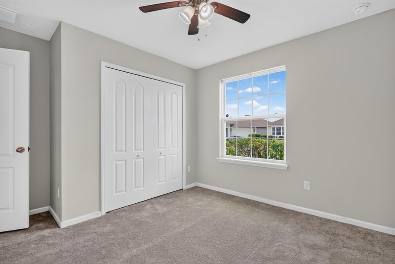 Hallway with closet doors and window at 10066 Andean Fox Dr, Jacksonville, FL 32222