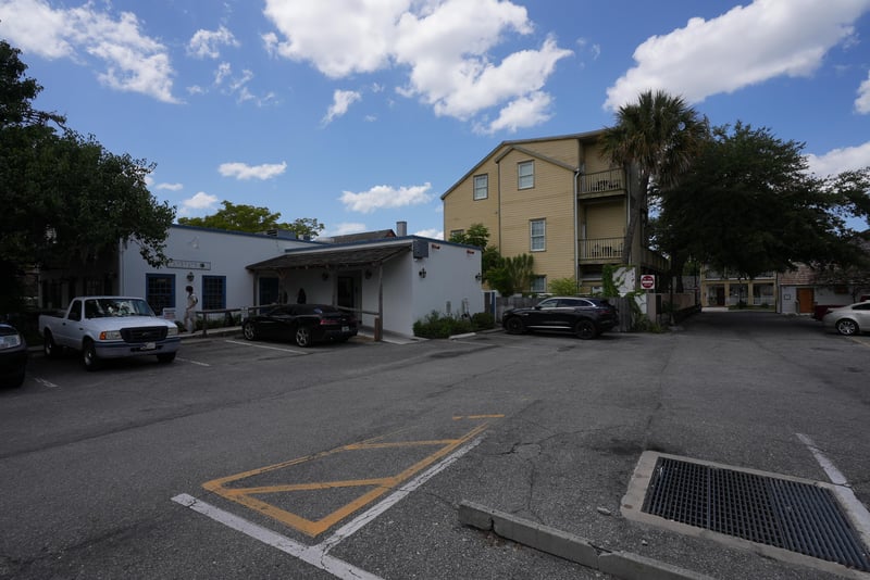 Parking area and rear facade of the yellow multi-story building at 29 Cuna St, St. Augustine, FL 32084