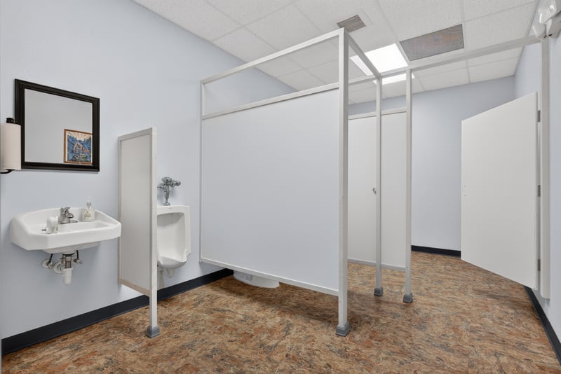 Restroom with sinks and stall dividers at 1038 County Rd 315, Melrose