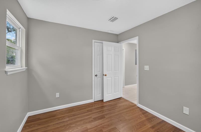 Hallway with closet doors at 7015 Miss Muffet Ln N, Jacksonville, FL 32210