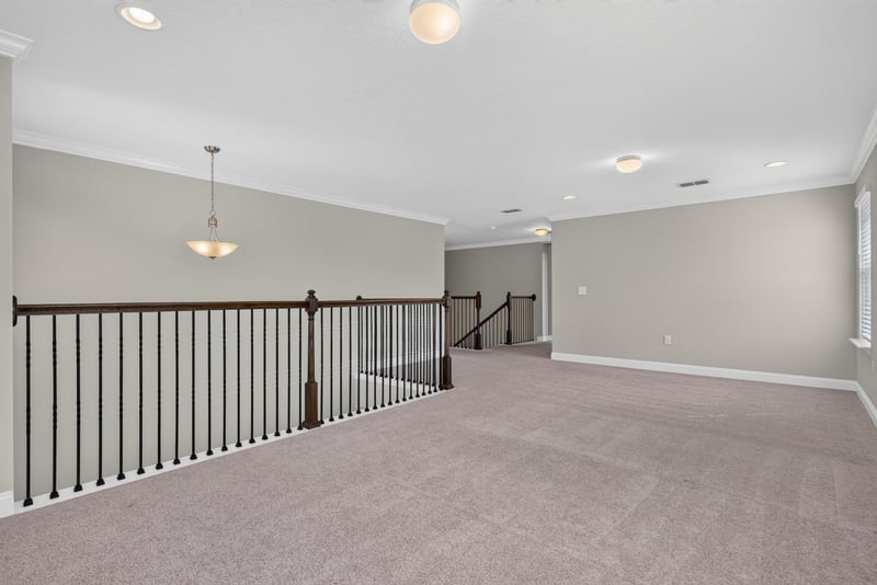 Upstairs hallway with black stair railing at 2580 Cold Stream Ln, Green Cove Springs, FL 32043