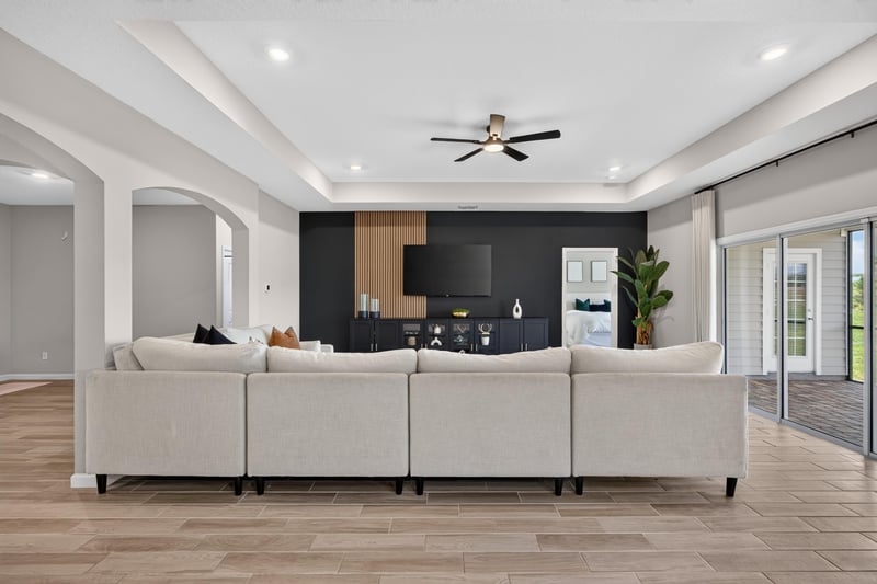 Living room with sofa, TV and tray ceiling at 9942 Lovage Ln, Jacksonville, FL 32219