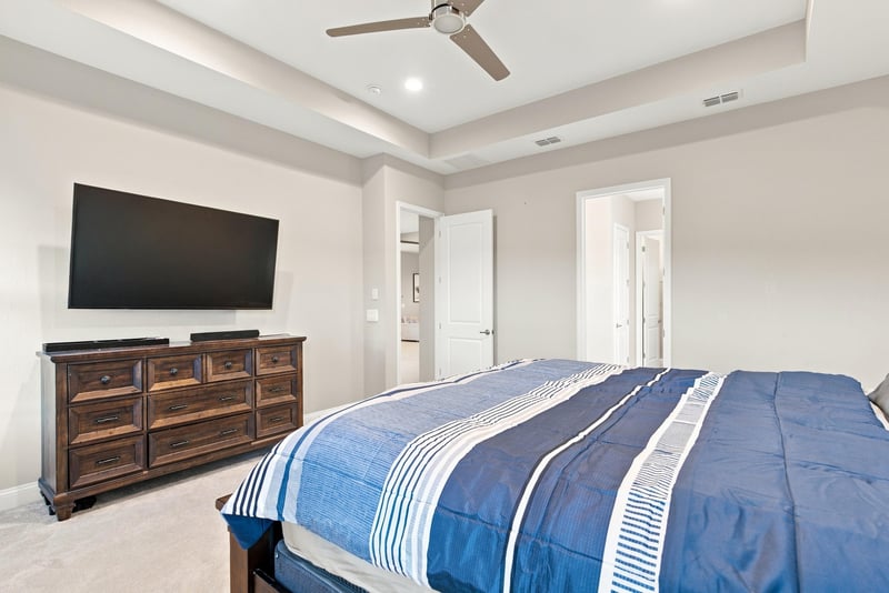 Primary bedroom with mounted TV and dresser at 27 Holly Rdg Wy, St. Augustine, FL