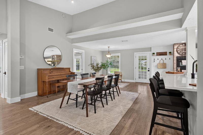 Dining table with open kitchen island beyond at 1161 Whispering Pines Rd, Jacksonville, FL 32259