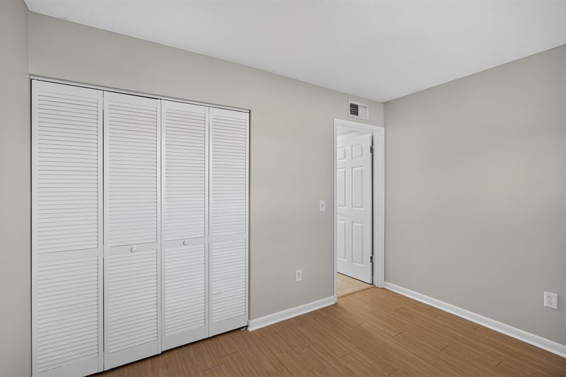 Bedroom closet with louvered doors at 700 W Pope Rd unit h61, St. Augustine, FL 32080