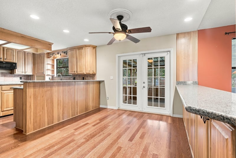 Kitchen breakfast bar with view to French doors at 2915 Trenton Ct, Orange Park, FL