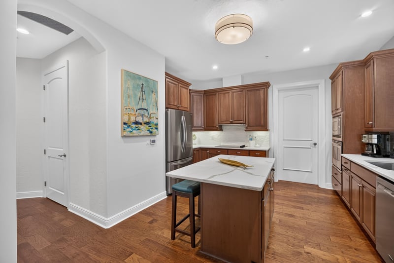 Kitchen view toward hallway with wood cabinets at 140 Ave De La Mer, Palm Coast, FL 32137